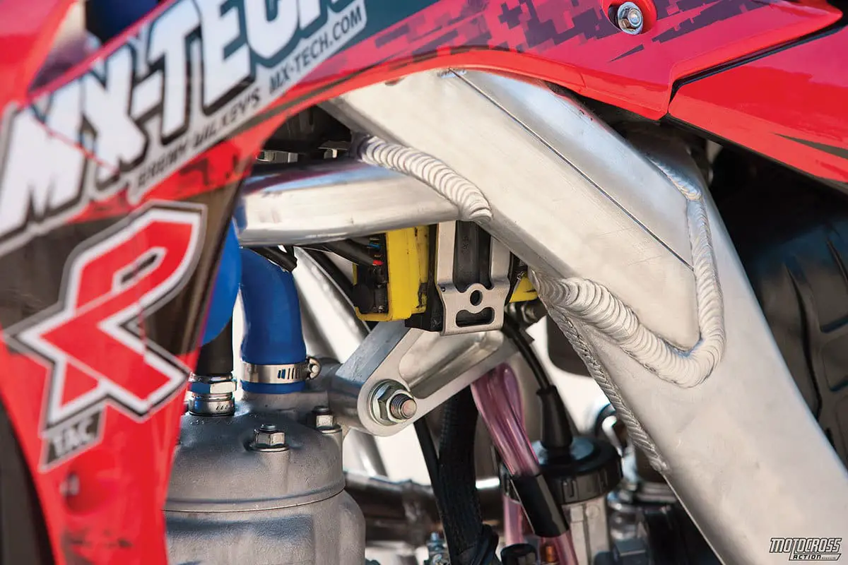 A custom bracket was made under the tank to hold the black box due to the steering damper being in the way on the head tube.