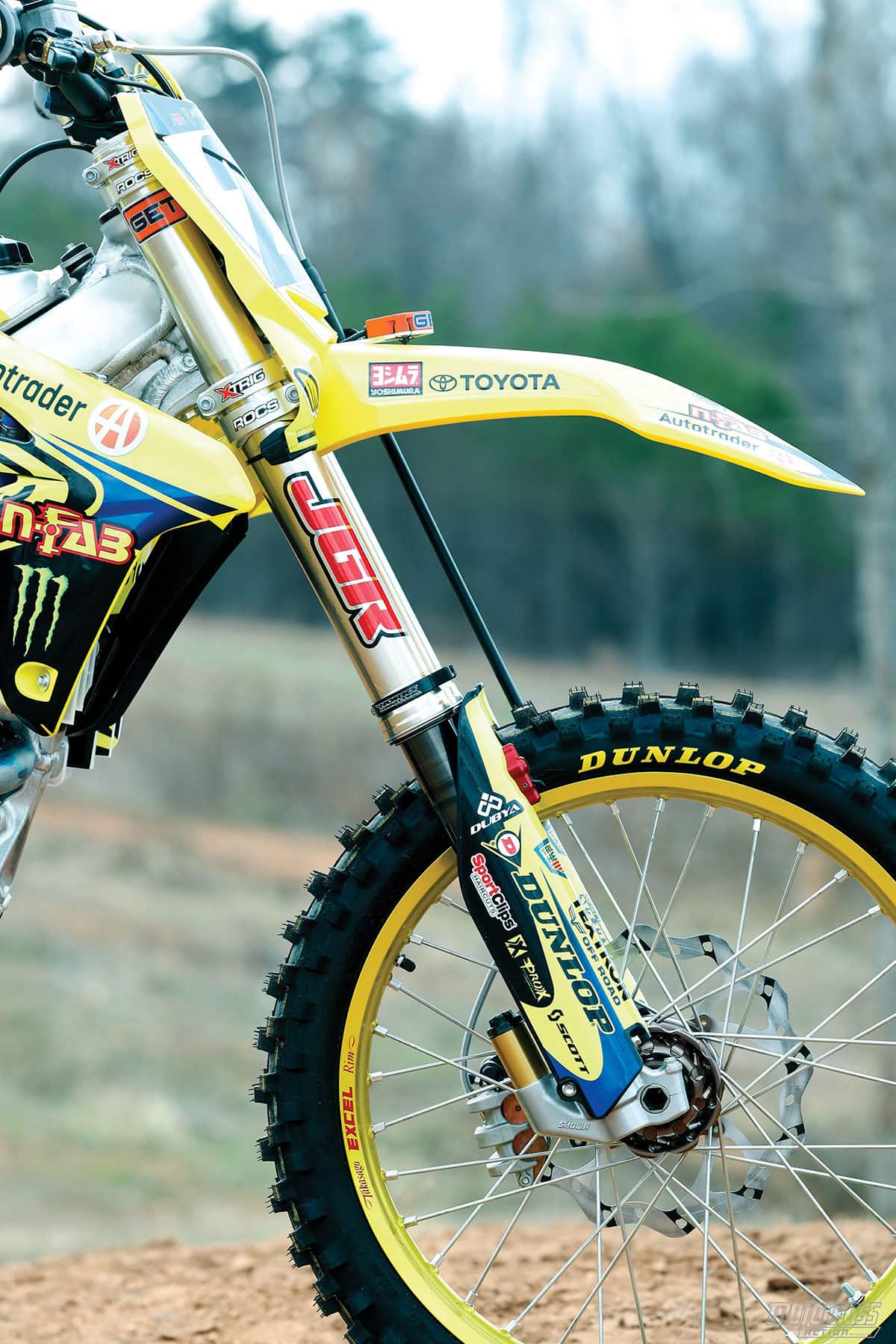 The stock Showa TAC forks are horrible. JGRMX installed their spring/air hybrid kit on it. It was a vast improvement.